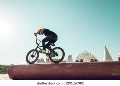 BMX Rider Doing Tricks In The Streets.Guy With A Bmx Bike In The City