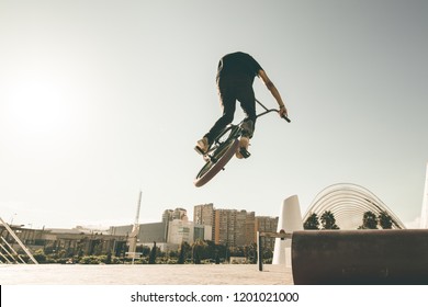 BMX Rider Doing Tricks In The Streets.Guy With A Bmx Bike In The City