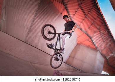 BMX Rider Makes A TAilwhip Trick. Young Man Doing Tricks In The Air On A BMX Bike. BMX Freestyle