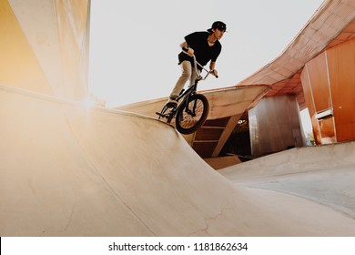 BMX rider makes a TAilwhip trick. Young man doing tricks in the air on a BMX bike. BMX freestyle - Powered by Shutterstock