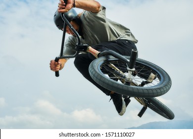 Bmx rider is making extreme stunts in the skate park near the mountains.                 - Powered by Shutterstock