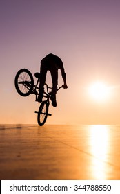 BMX silhouette rider at sunset 