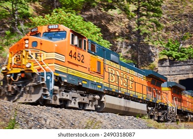 BNSF Freight Train in Motion Through Columbia Gorge Lush Landscape