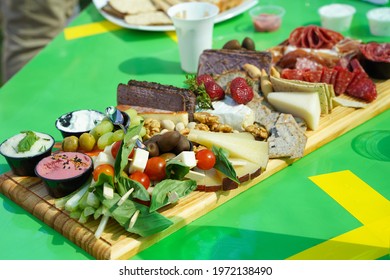 Board Of Appetizers Assortment On Green Table. Salty, Sweet Snacks Variety