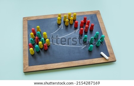 Board with arrows and colored figures. Cultural factors affect marketing concept.