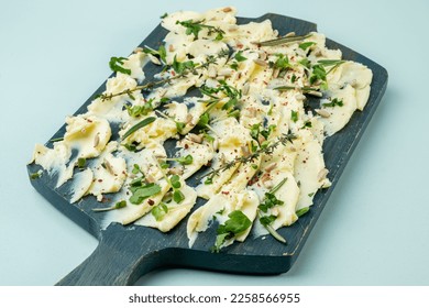 Board with butter, herbs, spices and seeds, close-up. Trend dish. - Shutterstock ID 2258566955