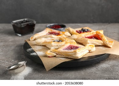 Board With Danish Pastry On Grunge Background