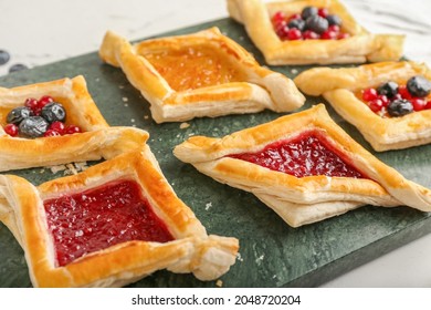 Board With Danish Pastry On Light Background