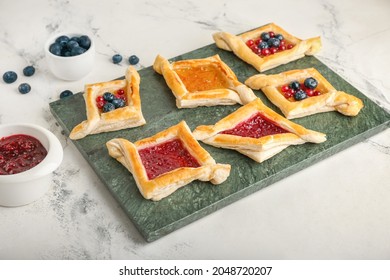 Board With Danish Pastry On Light Background