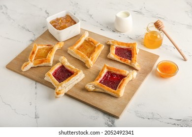 Board With Danish Pastry On Light Background