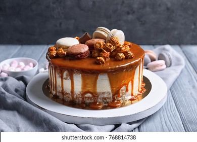Board with delicious caramel cake on table - Shutterstock ID 768814738