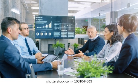 Board of Directors Has Annual Meeting, Diverse Group of Business People in the Modern Conference Room Discuss Statistics and Work Results. In the Background Projector Showing Company Growth. - Shutterstock ID 1031044363