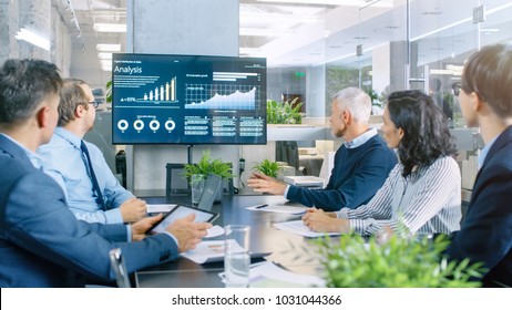 Board Of Directors Has Annual Meeting, Diverse Group Of Business People In The Modern Conference Room Discuss Statistics And Work Results. In The Background Projector Showing Company Growth.