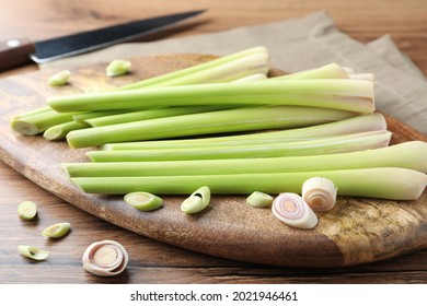 Board With Fresh Lemongrass Stalks On Wooden Table, Closeup