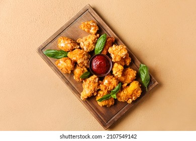 Board With Fried Popcorn Chicken, Tomato Sauce And Basil On Color Background