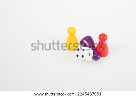 Board game concept colorful pawns with a six sided dice