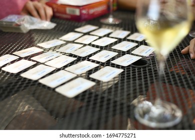 Board Game At A Winery. Family Playing Games Together With Wine.