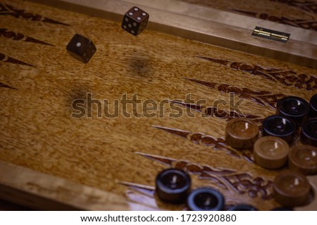 Board games wooden board of backgammon (tawla). Close-up details and checkers