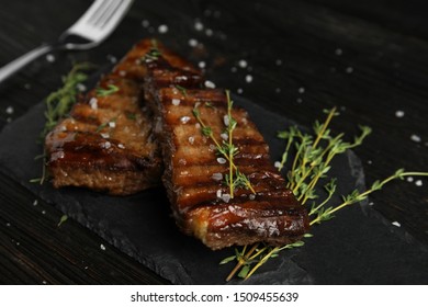 Board with grilled meat on wooden table - Shutterstock ID 1509455639