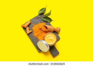 Board with jar and ingredients for turmeric mask on yellow background