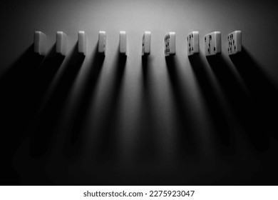 board logic game for the whole family and friends of dominoes. light-colored dominoes with black dots on a light and mirror background - Powered by Shutterstock