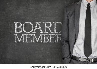 Board Member On Blackboard With Businessman In A Suit On Side