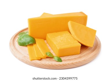 Board with pieces of tasty cheddar cheese and basil on white background - Shutterstock ID 2304399775