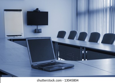 Board Room In Office Block With Laptop And Video Conferencing Equipment