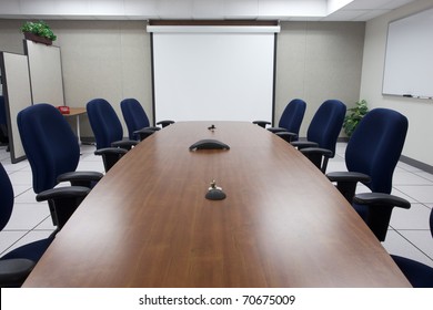 The Board Room Is Ready For An Important Meetings With Blank Screen Up And Ready For Any Message Needed.