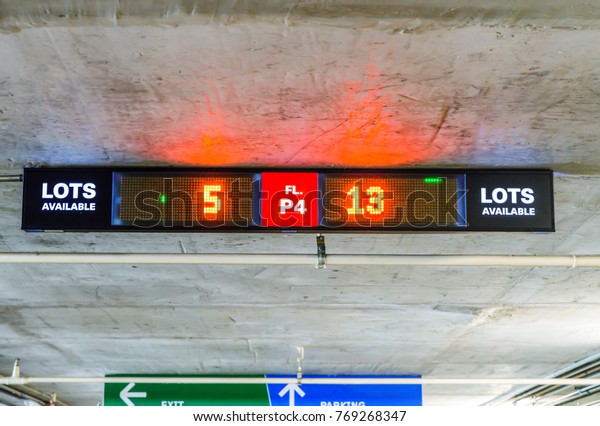 Board shows the direction transport for car parking\
in the shopping mall.