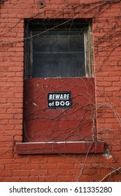 Boarded Up Window With Sign Beware Of Dog