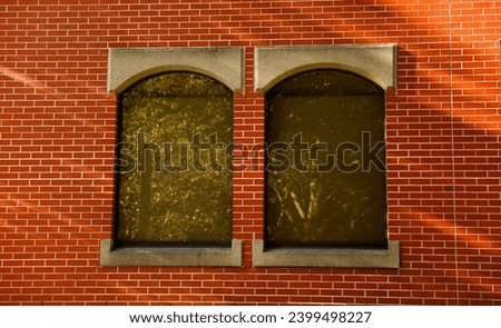 Boarded windows on urban buildings as precaution against riots, symbolizing protection and societal unrest, evoking a sense of caution and resilience