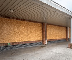 Boarded Up Windows Of A Supermarket That Has Recently Closed Down.