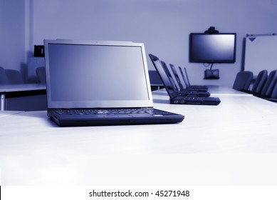 Boardroom With Laptops And Video Conferencing Equipment