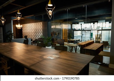 Boardroom Table And Chairs Sitting Empty In The Work Area Of A Large Modern Office Space After Business Hours