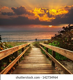 Boardwalk On Beach At Sunrise