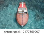 Boat with American flag Riva Aquarama top view. Exclusive expensive wooden boat Riva Aquarama on azure water, top view. Riva boat aerial view.