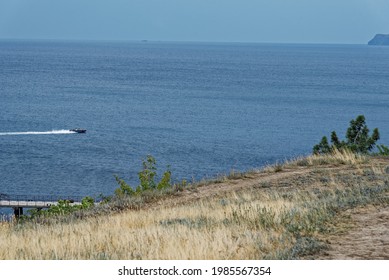 A Boat Breaking Waves In The Sea