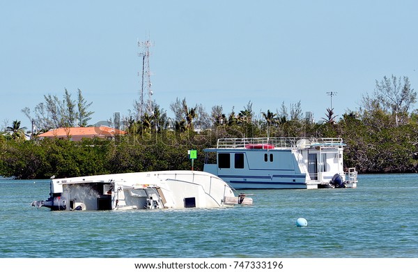 A boat is capsized and sinking after Hurricane\
Irma, in Key West, Florida.