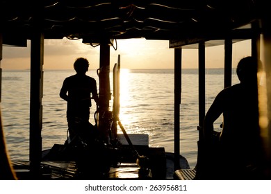 Boat Captain Silhouette On Sunset Background