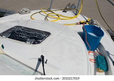 Boat Cleaning Equipment. Plastic Bucket, Hose With Water Spray Gun, Mop Laying On The Yacht. Close Up. Yacht Maintenance Concept.