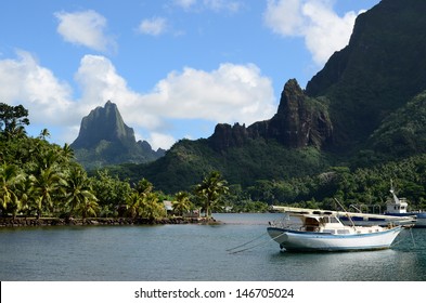 Boat In Cooks Bay With Moua Puta Mountain In The Background On The Tropical Pacific Island Of Moorea, Near Tahiti In French Polynesia.