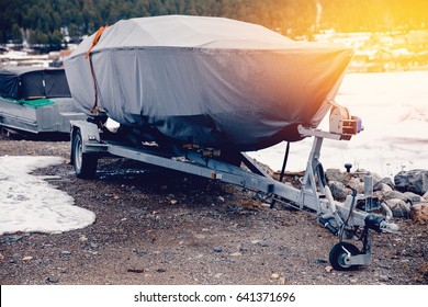 boat is covered with a tent, Cover, case against rain, snow and mud.. Warehouse on the boat pier. Concept training of boats, ships for the winter in the home.
