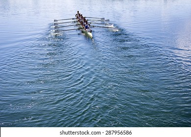 Boat coxed eight Rowers rowing on the tranquil blue lake - Powered by Shutterstock