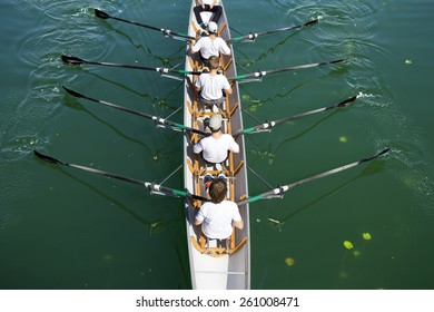 Boat Coxed Four Team Rowing On The Tranquil Lake