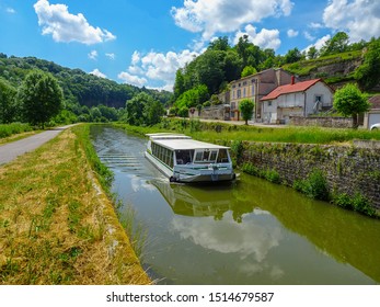 Boat Cruising A Canal In France On A Sunny Day