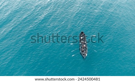 boat cruising on a beautiful clear sea. team work. Aerial view.