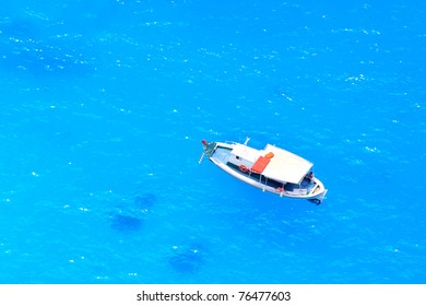 boat in deep blue water view from above