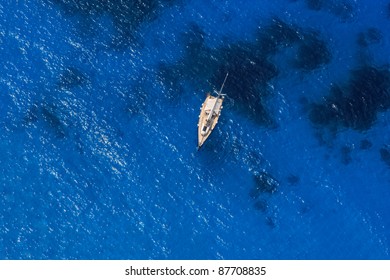 Boat In Deep Blue Water View From Above