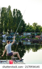 Boat Dock And Fisherman With A Fishing Rod On The Pier